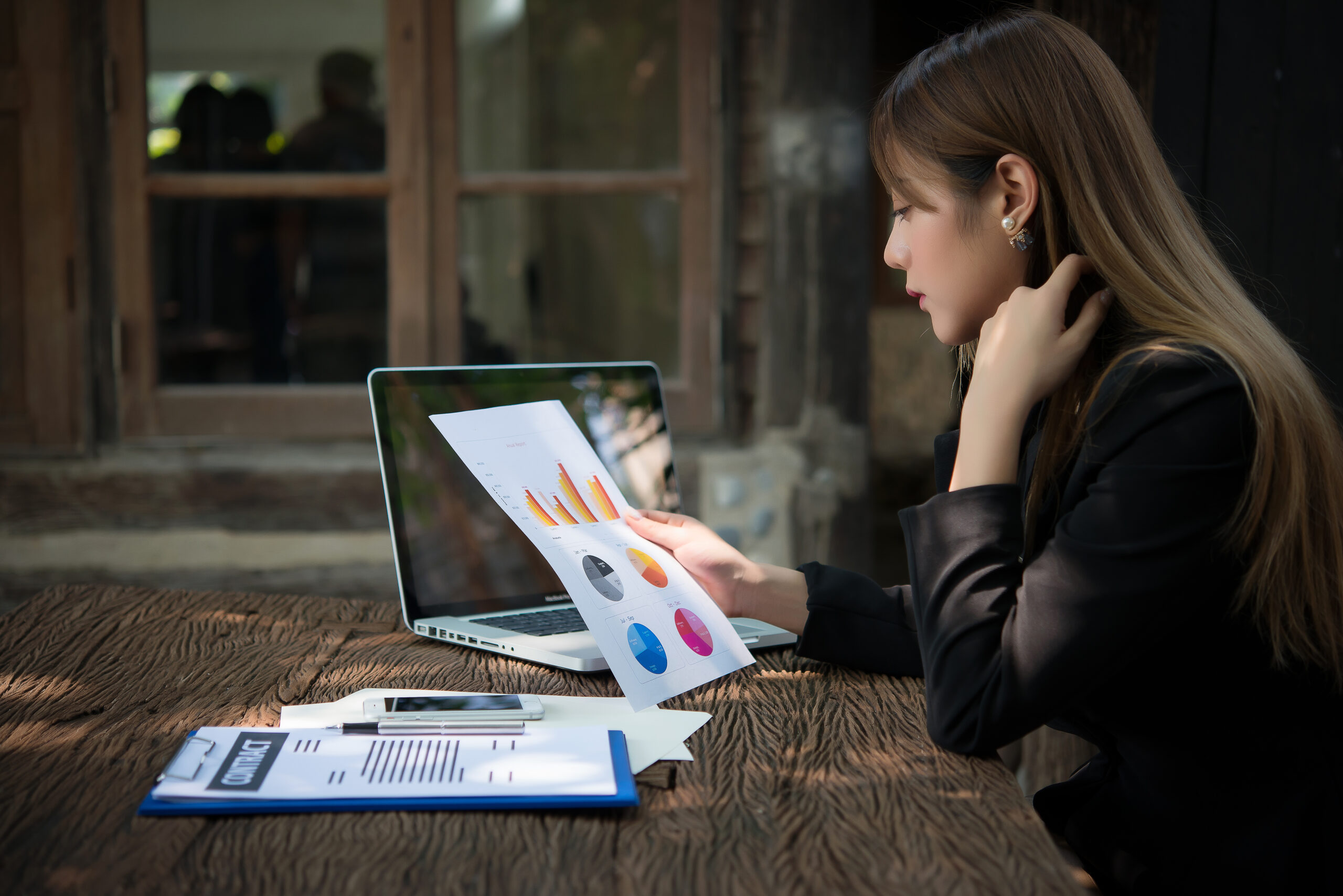 business woman working with documents graphs ,analyzing investm